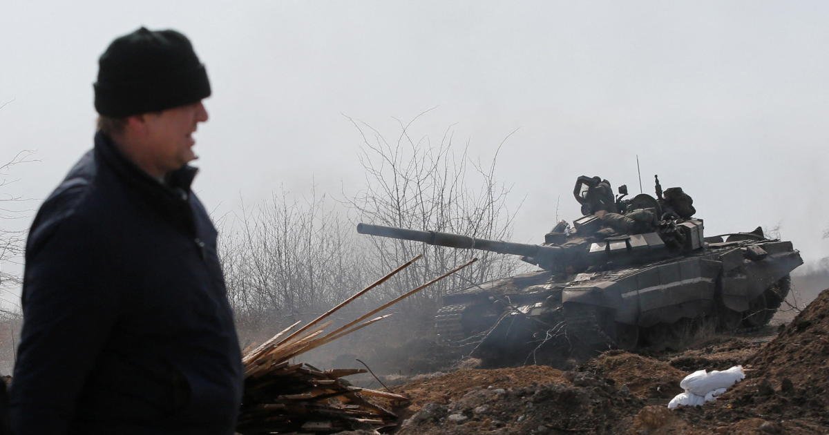 Service members of pro-Russian troops are seen on the outskirts of the besieged city of Mariupol