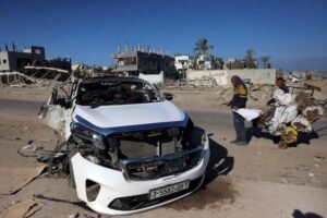 People check a car hit by an Israeli strike in Khan Yunis in the southern Gaza Strip on November 30, 2024, in which five people were reported killed, including three World Central Kitchen (WCK) workers, according to a report by the civil defense in the Palestinian territory. (AFP)