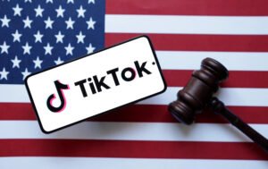 Illustration shows Tik Tok logo, U.S. flag and a judge gavel